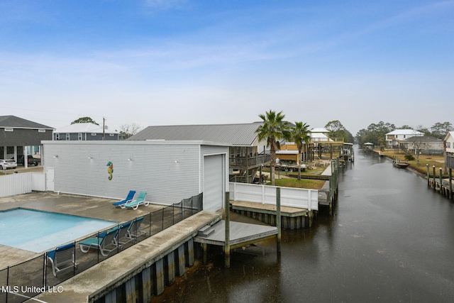 dock area featuring a water view and a patio