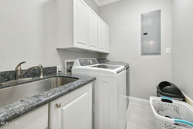 clothes washing area featuring washer and clothes dryer, cabinets, electric panel, sink, and light tile patterned floors