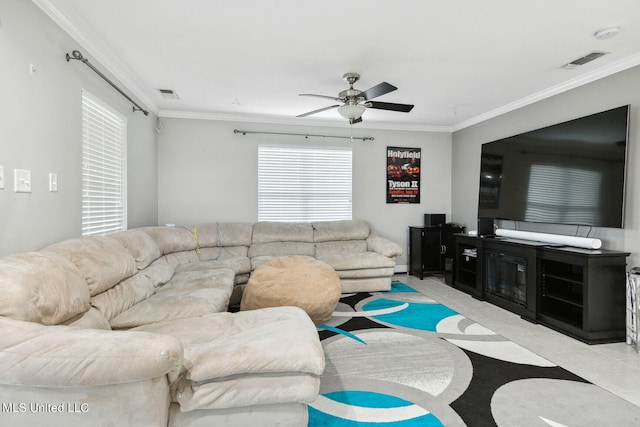 living room featuring ceiling fan and crown molding