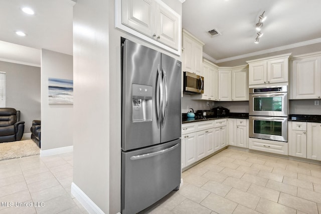 kitchen featuring white cabinets, light tile patterned flooring, stainless steel appliances, and ornamental molding