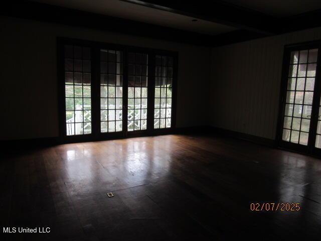 empty room with hardwood / wood-style flooring