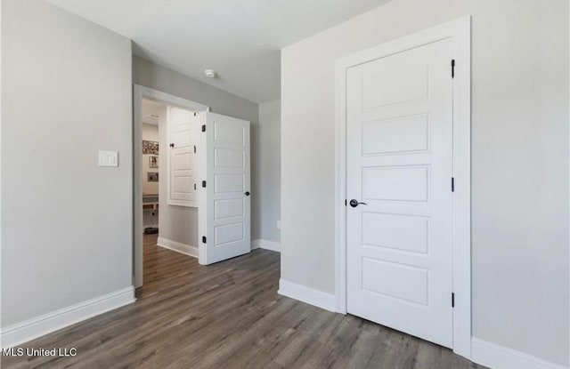 14451 Quail Ridge Dr, Gulfport, MS 39503 - unfurnished bedroom with wood finished floors and baseboards