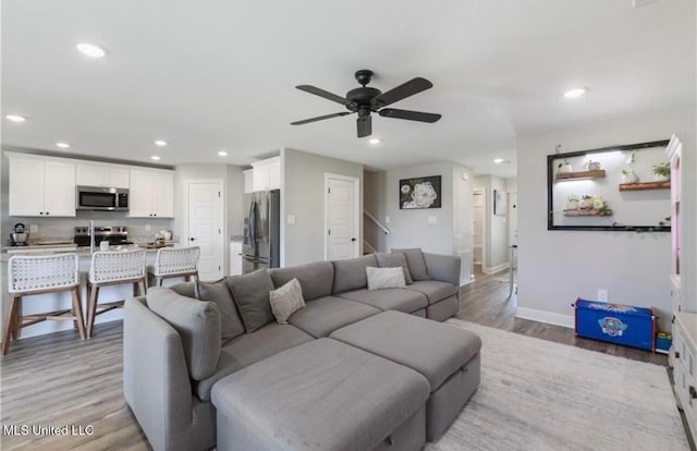14451 Quail Ridge Dr, Gulfport, MS 39503 - living area with light wood-style floors, recessed lighting, ceiling fan, baseboards, and stairs