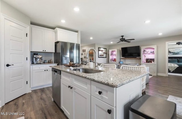 14451 Quail Ridge Dr, Gulfport, MS 39503 - kitchen with a sink, appliances with stainless steel finishes, ceiling fan, white cabinets, and dark wood-style floors