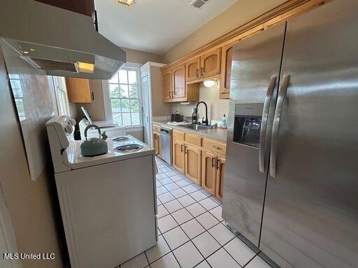1116 Main St, Natchez, MS 39120 - kitchen featuring under cabinet range hood, a sink, stainless steel appliances, light countertops, and light tile patterned floors