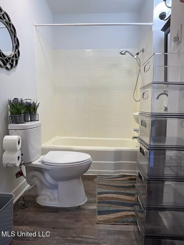 1116 Main St, Natchez, MS 39120 - bathroom with bathtub / shower combination, toilet, and wood finished floors
