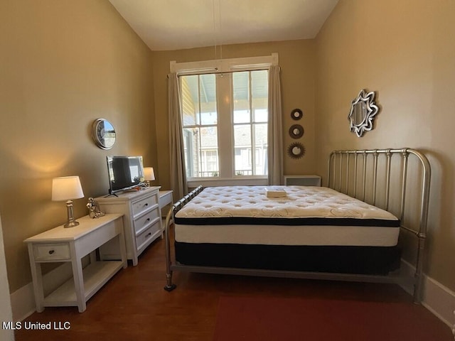 1116 Main St, Natchez, MS 39120 - bedroom with vaulted ceiling and dark wood-style flooring