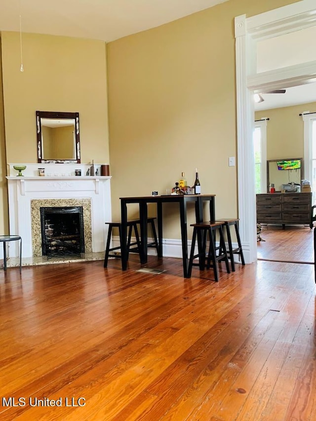 1116 Main St, Natchez, MS 39120 - living room featuring hardwood / wood-style floors, a fireplace, and baseboards