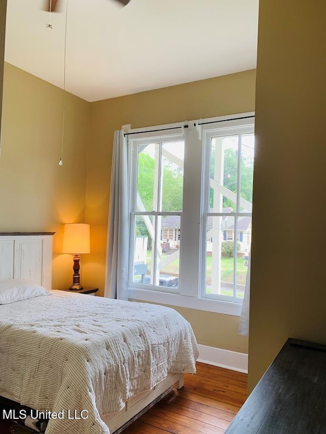 1116 Main St, Natchez, MS 39120 - bedroom with hardwood / wood-style floors, multiple windows, and baseboards