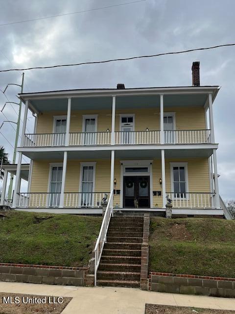 1116 Main St, Natchez, MS 39120 - view of front of property with a balcony, covered porch, and stairs