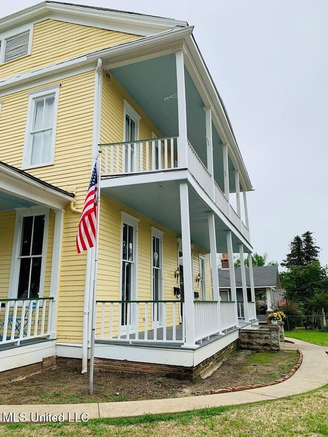 1116 Main St, Natchez, MS 39120 - view of home's exterior with a balcony and covered porch