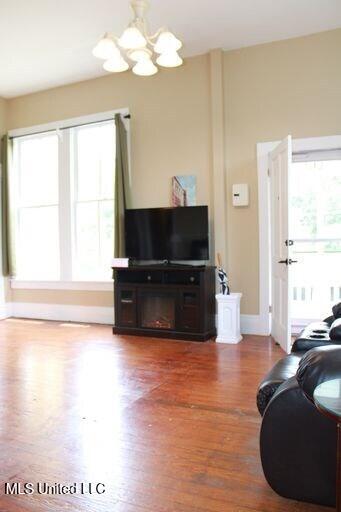1116 Main St, Natchez, MS 39120 - living area with wood finished floors, baseboards, plenty of natural light, and a chandelier