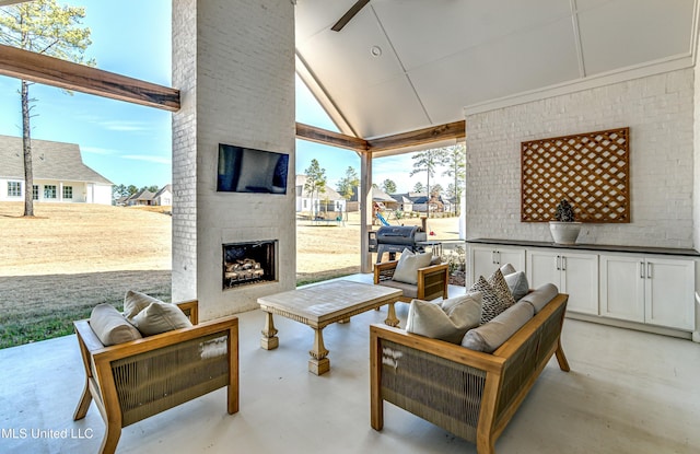 view of patio with area for grilling and an outdoor living space with a fireplace