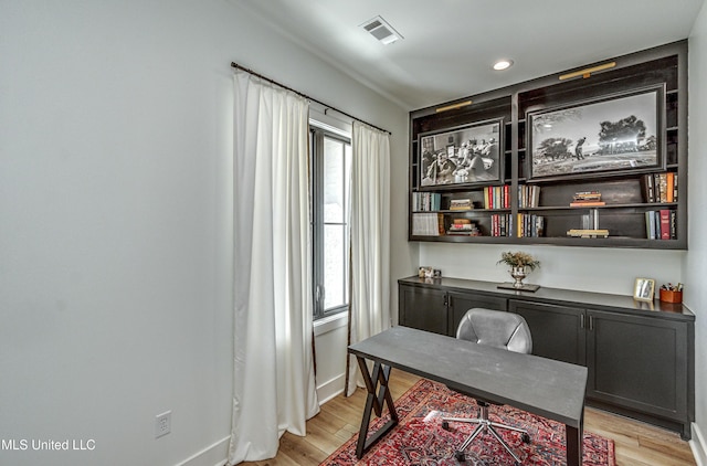 office with plenty of natural light and light hardwood / wood-style floors