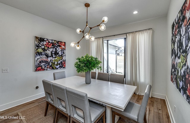 dining space with a chandelier and hardwood / wood-style floors