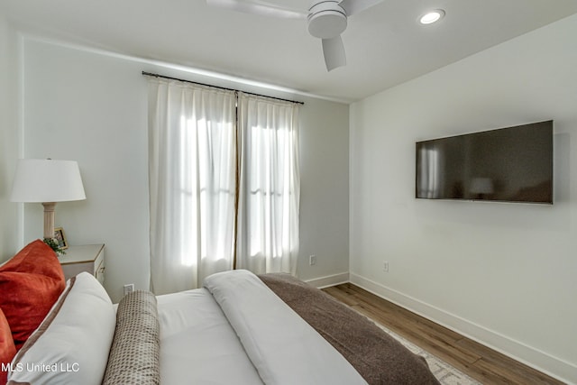 bedroom with ceiling fan and hardwood / wood-style floors