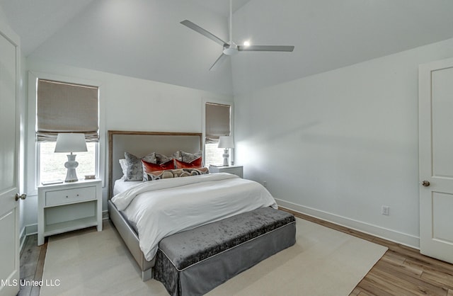 bedroom featuring lofted ceiling, ceiling fan, and light wood-type flooring