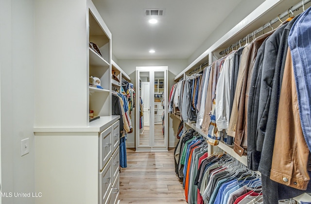 spacious closet featuring light hardwood / wood-style flooring