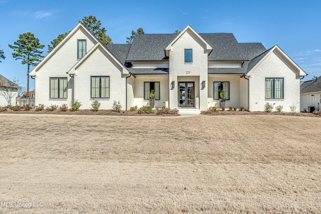 view of front of house with cooling unit and a front lawn