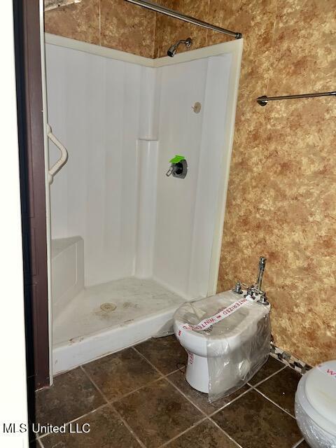 bathroom featuring a bidet, toilet, and a shower