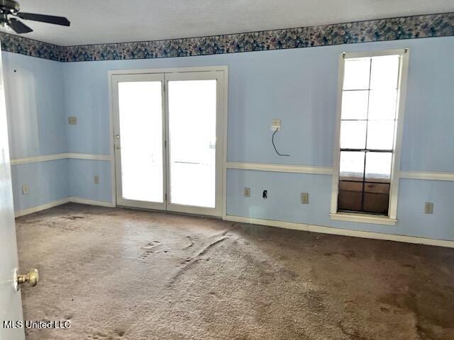 unfurnished room with ceiling fan and carpet flooring