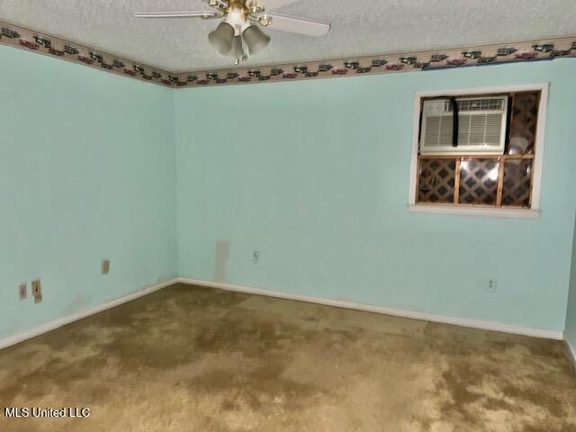 unfurnished room featuring ceiling fan, a wall mounted AC, and a textured ceiling