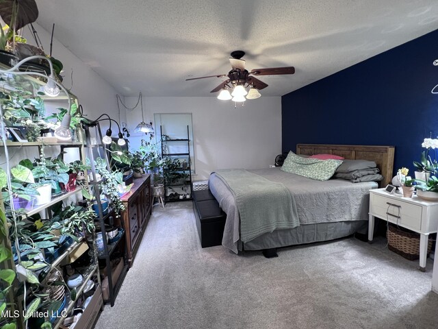 9929 Kahana St, Diamondhead, MS 39525 - carpeted bedroom featuring a textured ceiling and ceiling fan