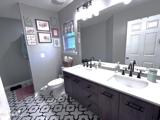 9929 Kahana St, Diamondhead, MS 39525 - full bathroom with double vanity, tile patterned floors, and a textured ceiling