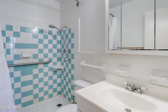 bathroom with a shower with shower curtain, vanity, tile walls, and toilet