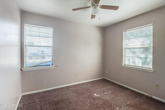 carpeted empty room featuring a healthy amount of sunlight and ceiling fan