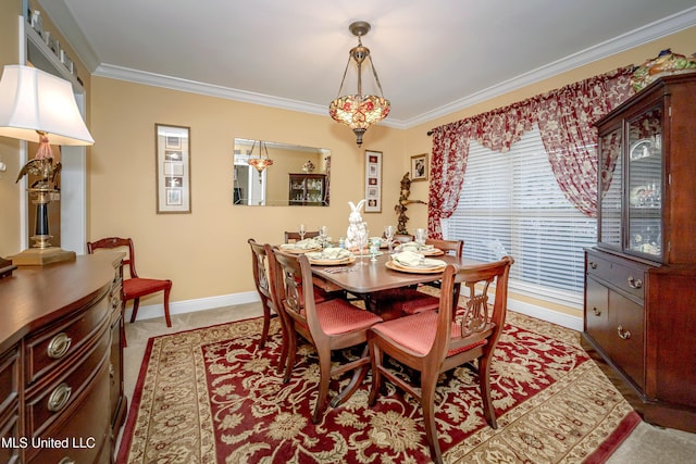 dining space with baseboards and crown molding