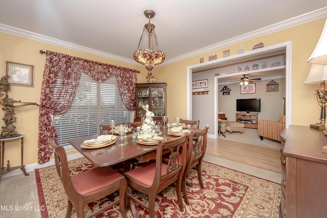 dining space with crown molding, ceiling fan, light wood-style floors, and baseboards