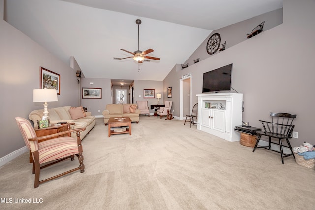 living room featuring carpet flooring, baseboards, vaulted ceiling, and a ceiling fan