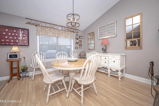 dining area featuring wood finished floors, a notable chandelier, and baseboards
