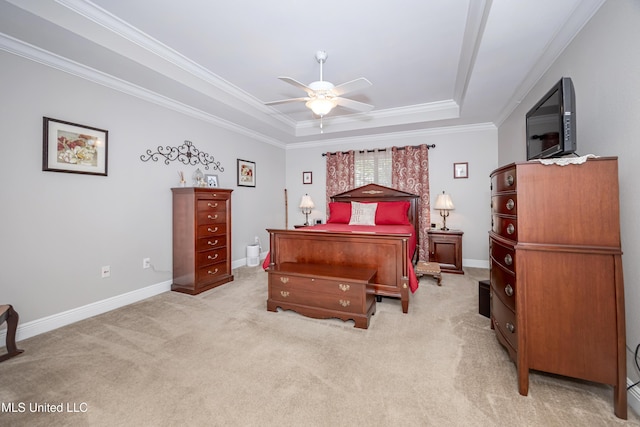 bedroom featuring crown molding, ceiling fan, a tray ceiling, light colored carpet, and baseboards