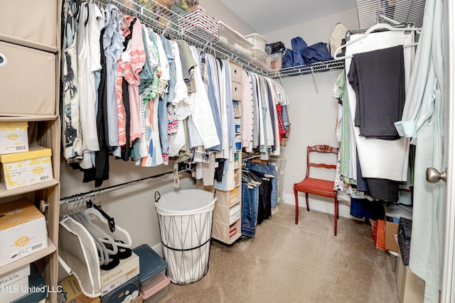walk in closet with carpet flooring