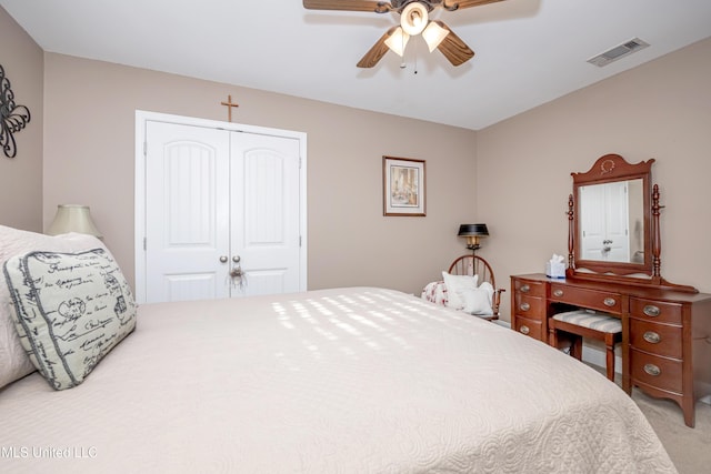bedroom featuring a closet, a ceiling fan, carpet flooring, and visible vents