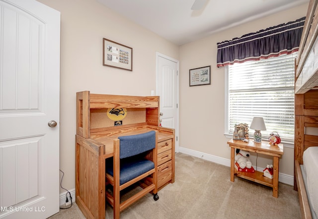 office area featuring ceiling fan, light colored carpet, and baseboards