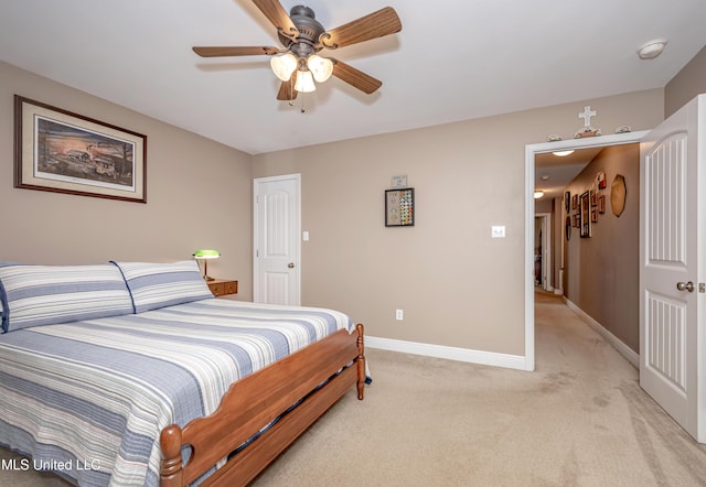 bedroom with baseboards, ceiling fan, and light carpet