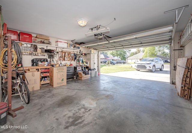 garage with a garage door opener and a workshop area