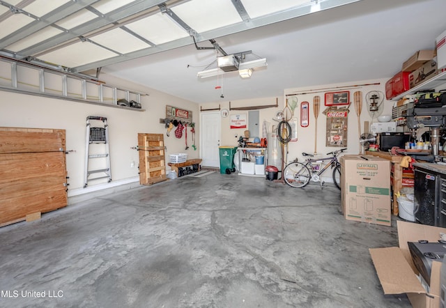 garage with a garage door opener and a workshop area