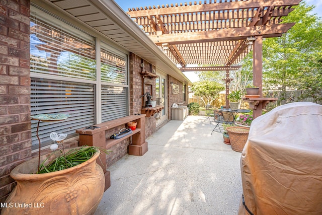 view of patio / terrace featuring area for grilling, a pergola, and fence