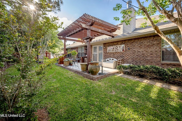 rear view of house with a pergola, a lawn, a patio, brick siding, and a chimney