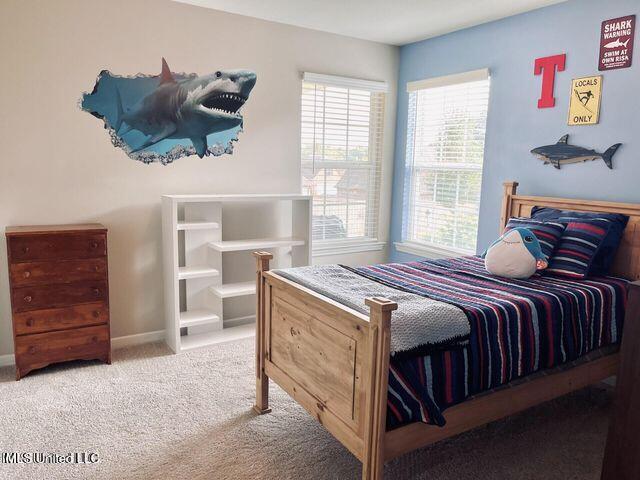 bedroom featuring carpet floors and baseboards