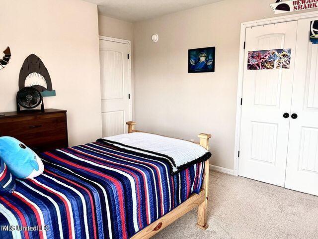 carpeted bedroom with a closet