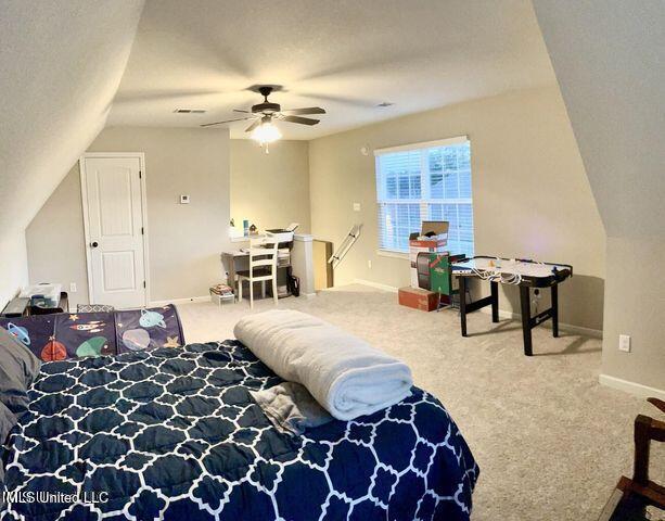 recreation room featuring lofted ceiling, carpet, baseboards, and ceiling fan