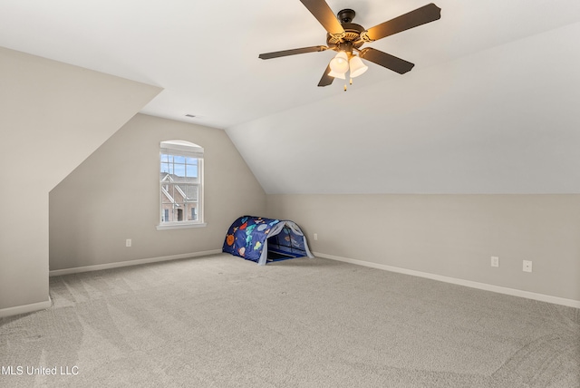 bonus room with a ceiling fan, baseboards, vaulted ceiling, and carpet flooring