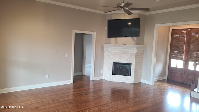 unfurnished living room featuring crown molding, dark hardwood / wood-style flooring, a fireplace, and ceiling fan