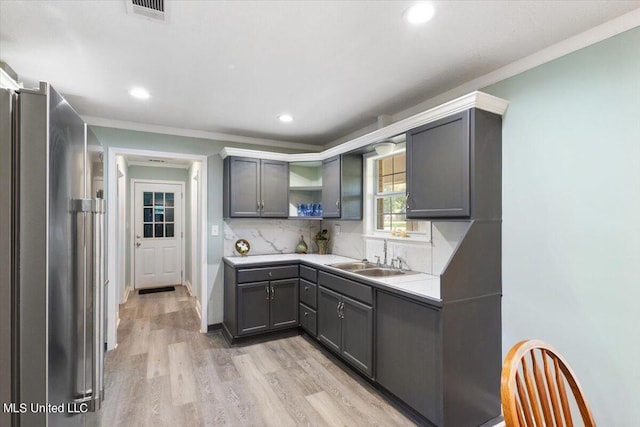 kitchen with gray cabinets, sink, high end refrigerator, and light hardwood / wood-style floors