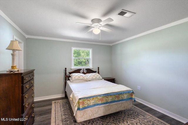 bedroom with ornamental molding, dark hardwood / wood-style floors, a textured ceiling, and ceiling fan